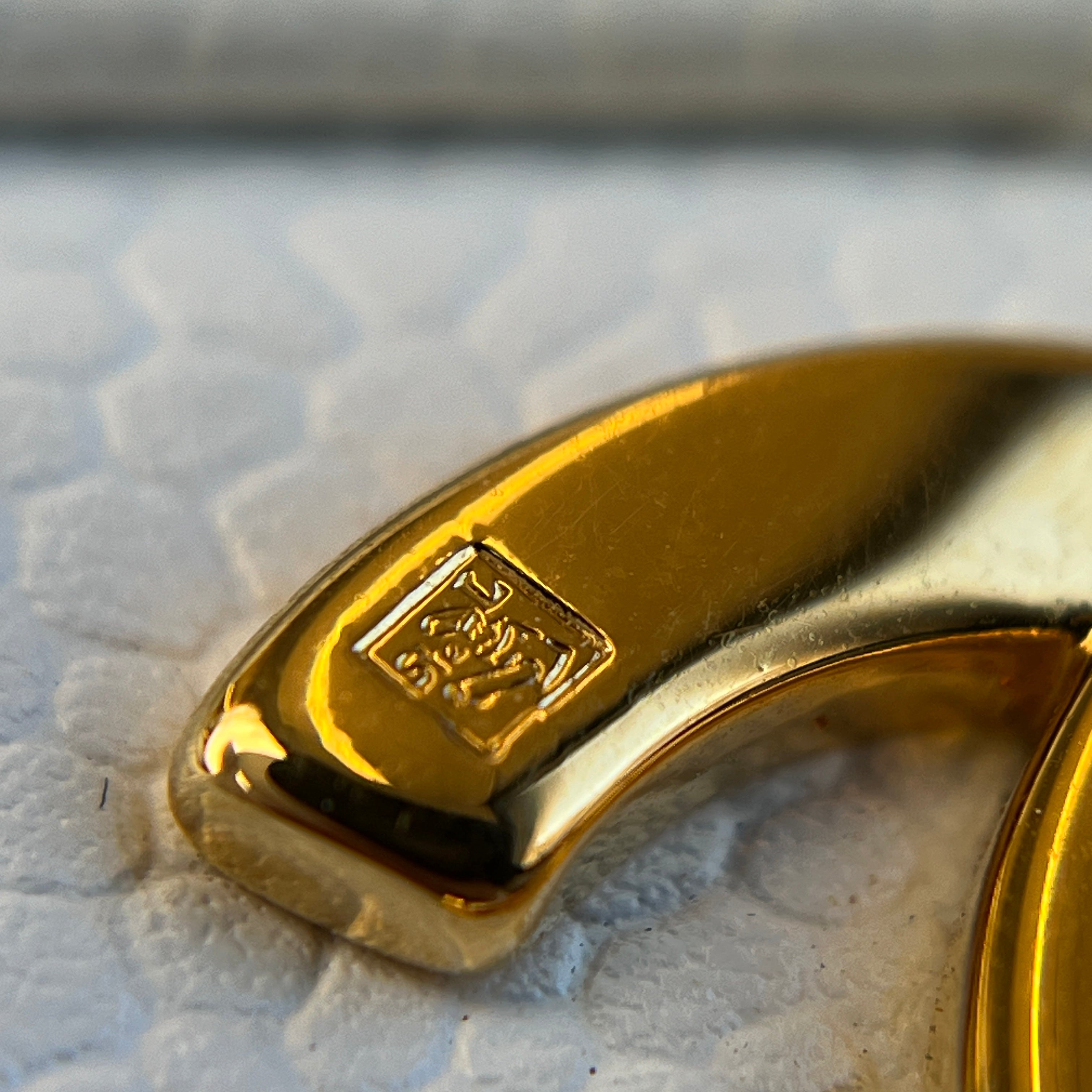 Why is 24K gold-plated hardware on vintage items more yellow than on new hardware?